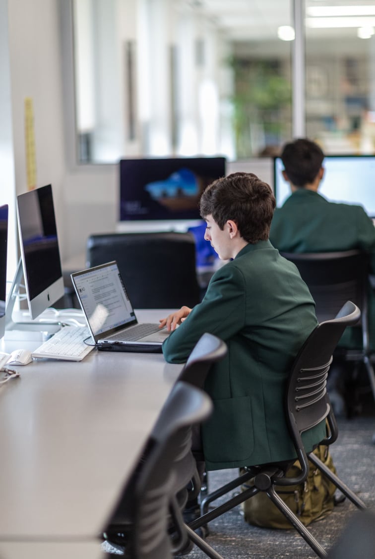 Students looking at computer