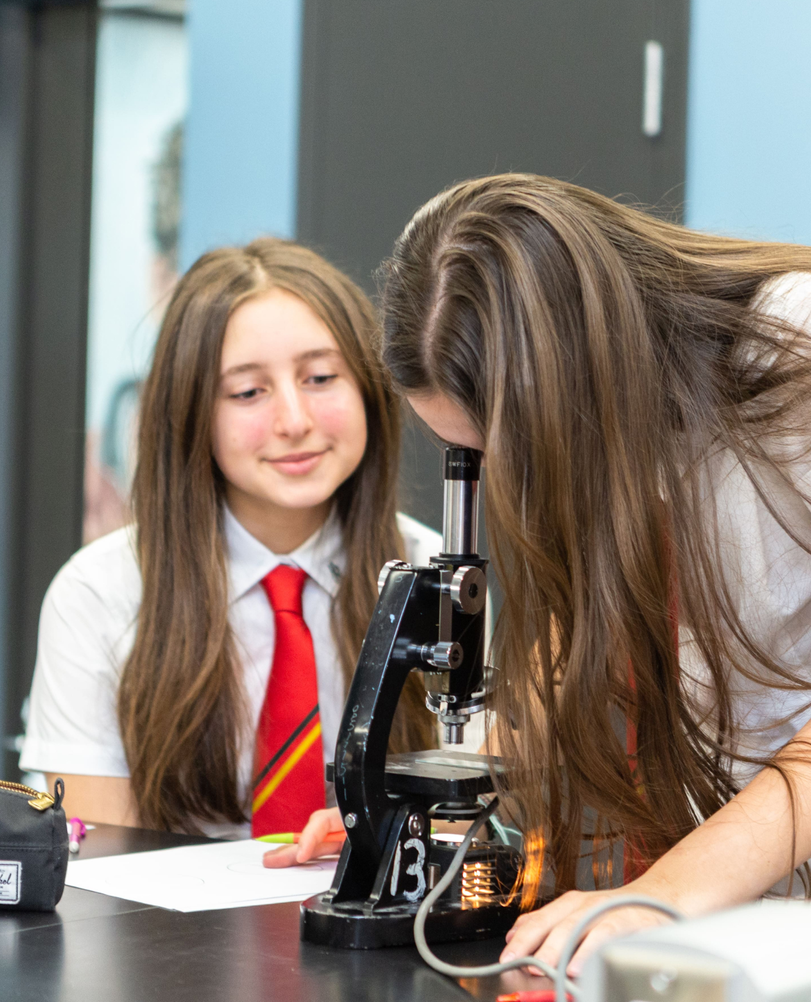 students looking through microscope